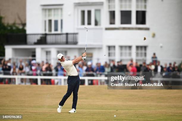 Rory McIlroy of Northern Ireland plays an approach shot on the 1st hole during Day Four of The 150th Open at St Andrews Old Course on July 17, 2022...