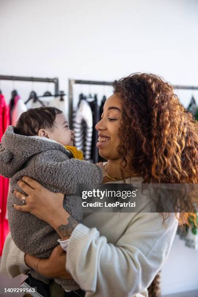 happy curly woman with her baby girl - dominican ethnicity stock pictures, royalty-free photos & images