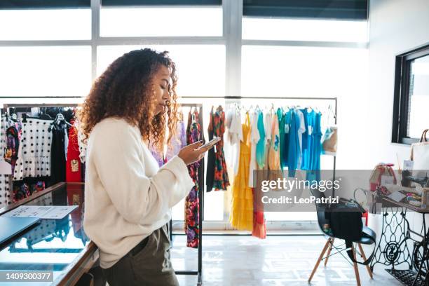 sales person in small business clothing store - damkläder bildbanksfoton och bilder