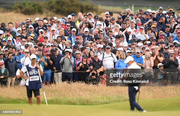 Spectators watch Rory McIlroy of Northern Ireland putt on the 3rd green during Day Four of The 150th Open at St Andrews Old Course on July 17, 2022...