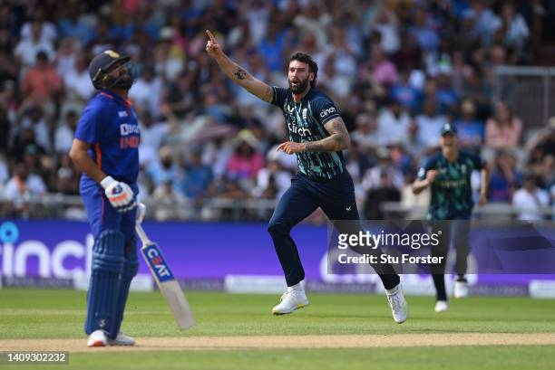 England bowler Reece Topley celebrates after taking the wicket of Rohit Sharma during the 3rd Royal London Series One Day International match between...