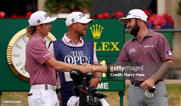 Cameron Young of the United States and Cameron Smith of Australia shake hands on the 1st hole during Day Four of The 150th Open at St Andrews Old...