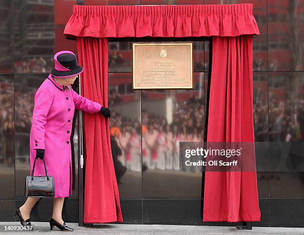 Queen Elizabeth II unveils a plaque during her visit to De Montfort University on March 8, 2012 in Leicester, England. The royal visit to Leicester...