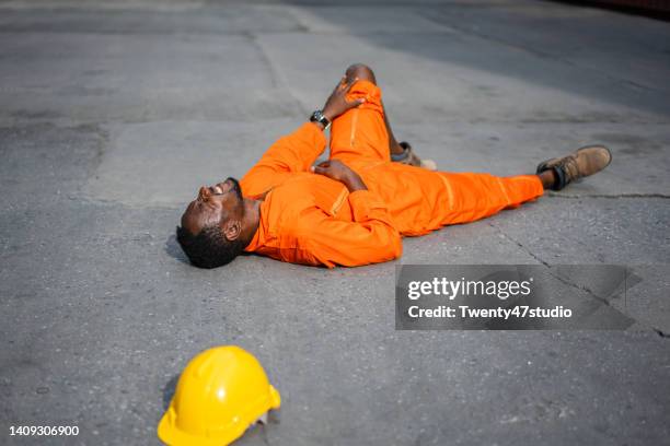 dock worker injured lay down on the floor - unconscious person stock pictures, royalty-free photos & images