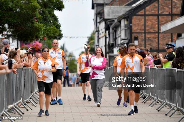Baton bearer Ruth Williams holds the Queen's Baton during the Birmingham 2022 Queen's Baton Relay during a visit to the town centre on July 17, 2022...