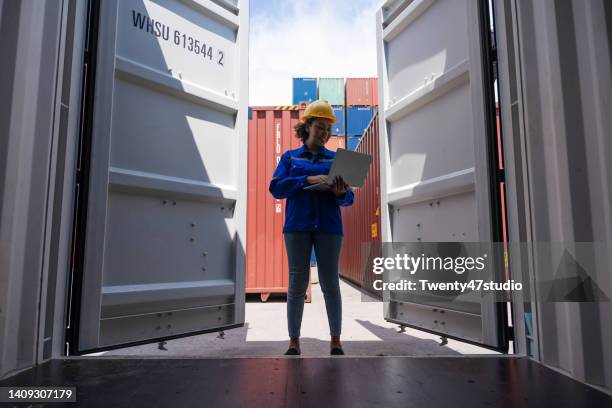 female worker opening the container box to check declare goods - docklands studio stock pictures, royalty-free photos & images