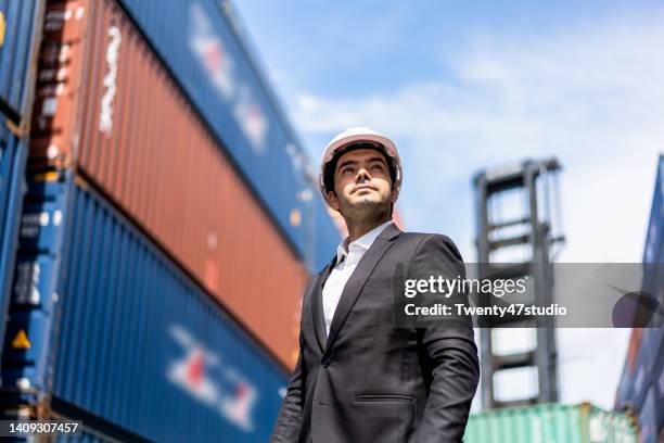 smart young businessman in commercial dock - docklands studio stock pictures, royalty-free photos & images