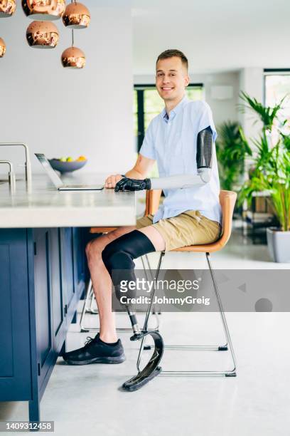full length portrait of relaxed businessman wearing prostheses - bionic arm stock pictures, royalty-free photos & images