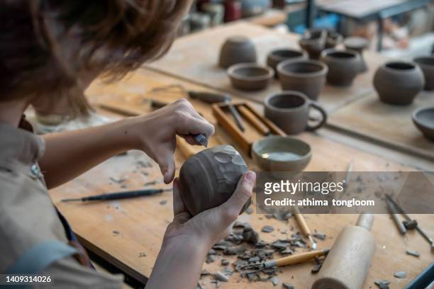 young potter making cups in pottery studio. - molding a shape stock pictures, royalty-free photos & images