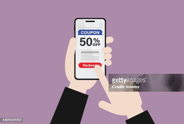 the customer holds a mobile phone with a 50 percent discount coupon - inexpensive stock illustrations
