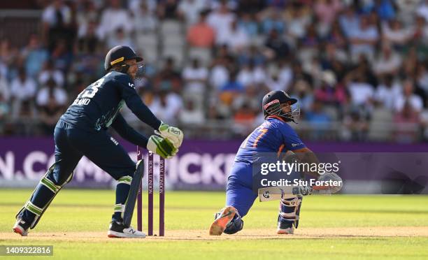 India batsman Rishabh Pant sweeps a ball to the boundary watched by England wicketkeeper Jos Buttler during the 3rd Royal London Series One Day...