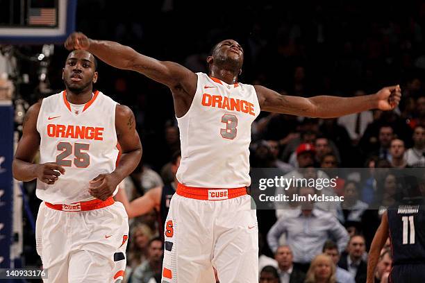 Dion Waiters of the Syracuse Orange reacts after a dunk against the Connecticut Huskies as Rakeem Christmas looks on during the quarterfinals of the...