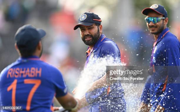 India captain Rohit Sharma celebrates by being sprayed with champagne by Rishabh Pant after the 3rd Royal London Series One Day International match...
