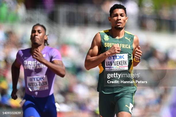 Alex Haydock-Wilson of Team Great Britain and Wayde van Niekerk of Team South Africa compete in the Men's 400m heats on day three of the World...