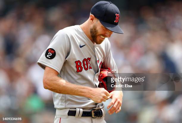 Chris Sale of the Boston Red Sox leaves the field with a dislocated pinky finger after getting hit by a line drive from Aaron Hicks of the New York...