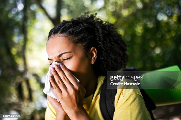 young woman hiker having allergy sneezing using handkerchief - allergy season stock pictures, royalty-free photos & images