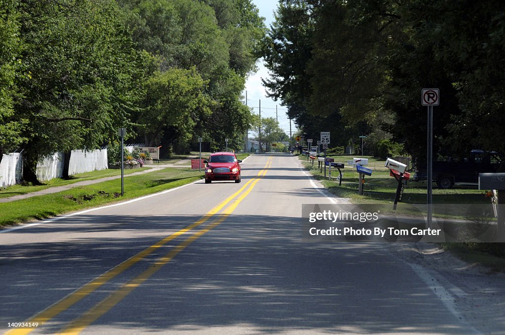 Car driving down a deserted street