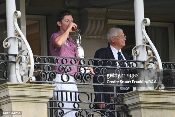 Cameron Smith of Australia holds the Claret Jug as he takes a drink on the balcony of the R&A Clubhouse following Day Four of The 150th Open at St...