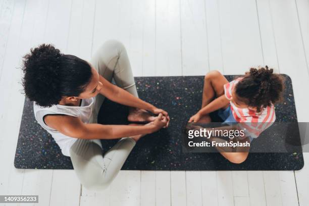 mother and daughter practising yoga at home - child yoga elevated view stock pictures, royalty-free photos & images