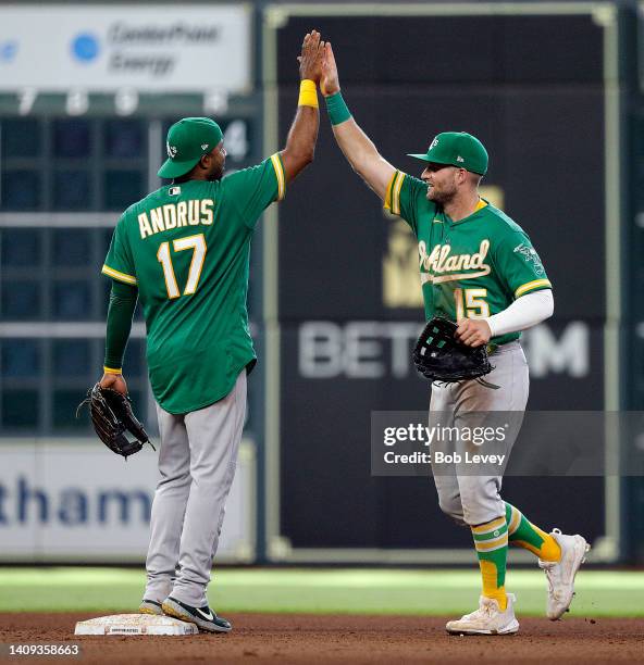 Elvis Andrus of the Oakland Athletics high fives Seth Brown as they defeat the Houston Astros 4-3 at Minute Maid Park on July 17, 2022 in Houston,...