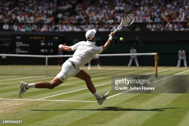 Novak Djokovic of Serbia stretches for a shot against Nick Kyrgios of Australia during their Men's Singles Final match on day fourteen of The...