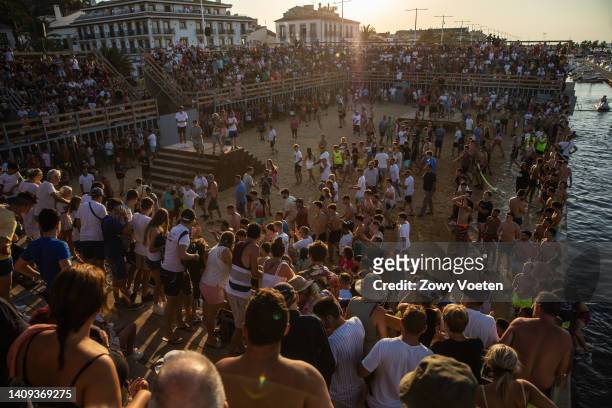Bull makes participants of the running of the bulls fall into the sea during the 'Bous a la Mar' festival on July 17, 2022 in Denia, Spain. The...