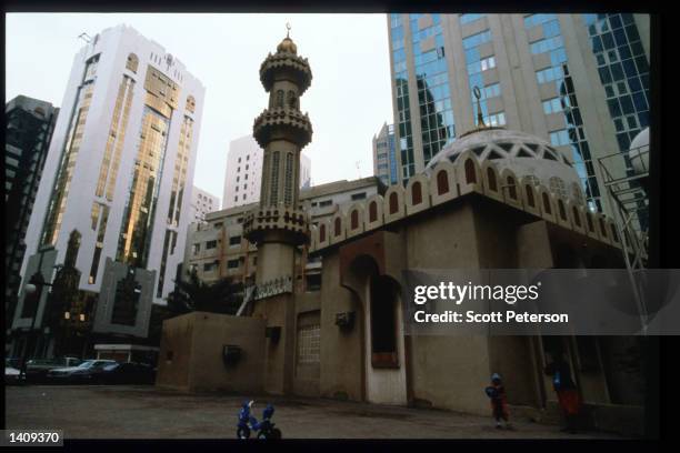 Modern buildings stand near a mosque December 20, 1996 in Abu Dhabi, United Arab Emirates. Since the 1960s the UAE has progressed from a largely...