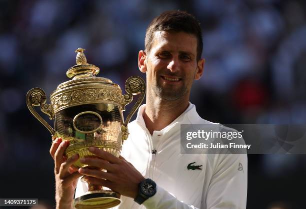 Novak Djokovic of Serbia poses for a photo with the trophy following his victory against Nick Kyrgios of Australia during their Men's Singles Final...