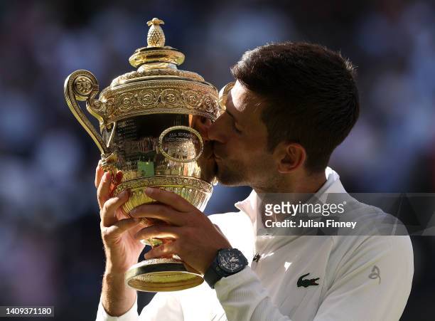 Novak Djokovic of Serbia poses for a photo with the trophy following his victory against Nick Kyrgios of Australia during their Men's Singles Final...
