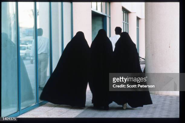 Women walk near modern buildings December 20, 1996 in Dubai, United Arab Emirates. Since the 1960s the UAE has progressed from a largely subsistence...