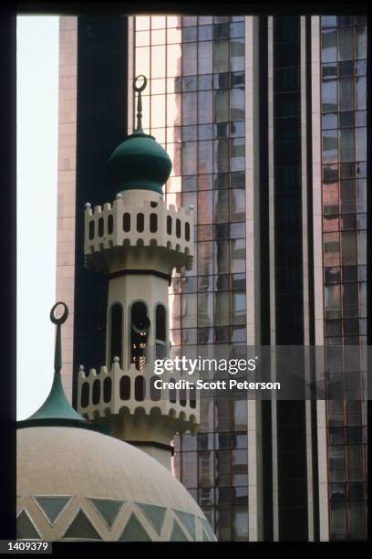 Modern buildings stand near a mosque December 20, 1996 in Abu Dhabi, United Arab Emirates. Since the 1960s the UAE has progressed from a largely...