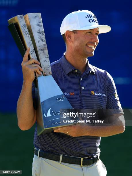 Chez Reavie of the United States poses with the trophy after putting in to win on the 18th green during the final round of the Barracuda Championship...