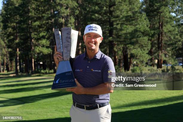 Chez Reavie of the United States poses with the trophy after putting in to win on the 18th green during the final round of the Barracuda Championship...