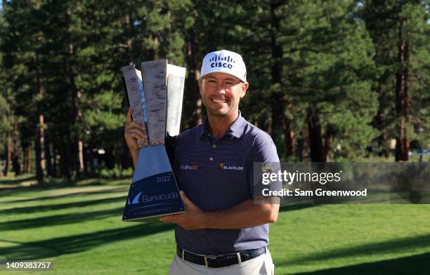 Chez Reavie of the United States poses with the trophy after putting in to win on the 18th green during the final round of the Barracuda Championship...
