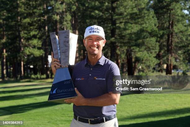 Chez Reavie of the United States poses with the trophy after putting in to win on the 18th green during the final round of the Barracuda Championship...