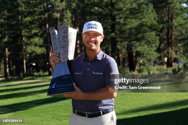 Chez Reavie of the United States poses with the trophy after putting in to win on the 18th green during the final round of the Barracuda Championship...