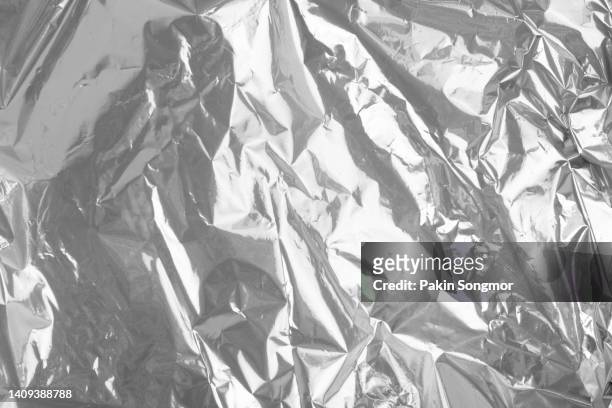 close up of plastic foil background, abstract background of a white color made of paper. - papel de alumínio - fotografias e filmes do acervo