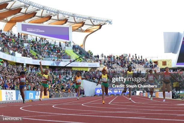 Shelly-Ann Fraser-Pryce of Team Jamaica crosses the finish line to win gold ahead of silver medalist Shericka Jackson of Team Jamaica and bronze...