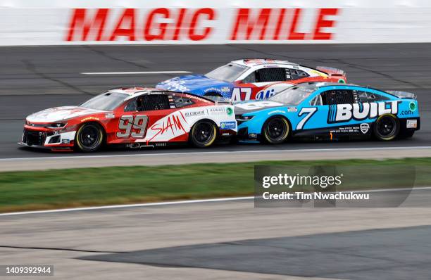 Daniel Suarez, driver of the SLAM! Chevrolet, and Corey LaJoie, driver of the Built.com Chevrolet, race during the NASCAR Cup Series Ambetter 301 at...