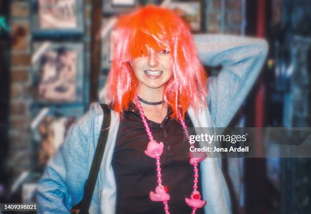 funny woman wearing wig and mardi gras beads - 2000s style stock pictures, royalty-free photos & images