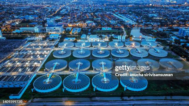 aerial view sewage treatment plant near downtown at night. - mineral water stock pictures, royalty-free photos & images