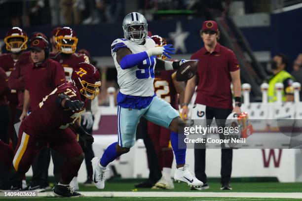 Demarcus Lawrence of the Dallas Cowboys runs the ball against the Washington Football Team during an NFL game at AT&T Stadium on December 26, 2021 in...