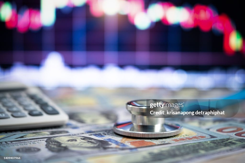 Stethoscope and money,Financial analysis, auditing or accounting - calculator calculators and dollar banknotes