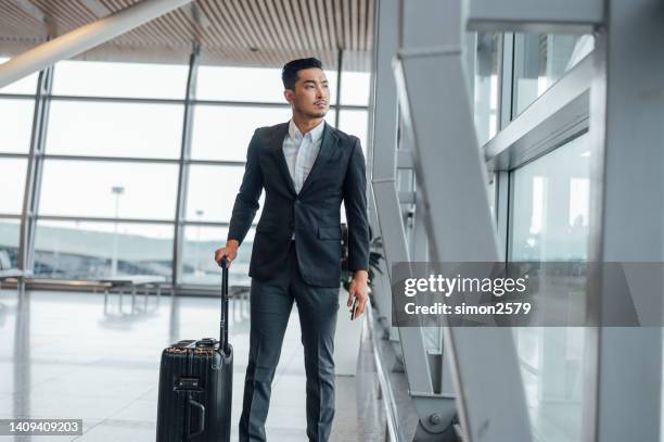 let nothing stand in the way of your success - business man walking with a bag in asia bildbanksfoton och bilder