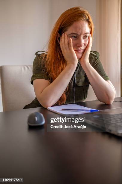 woman taking online courses with laptop and notebook and pen - pessoas notebook stock pictures, royalty-free photos & images