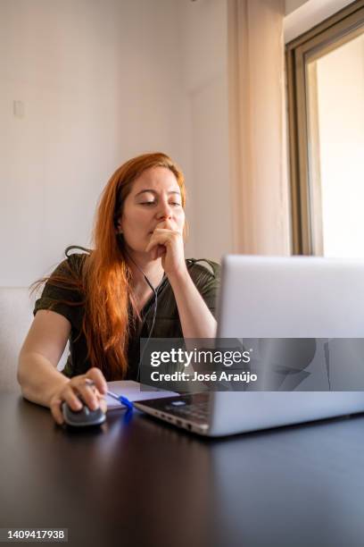 woman taking online courses with laptop and notebook and pen - pessoas notebook stock pictures, royalty-free photos & images