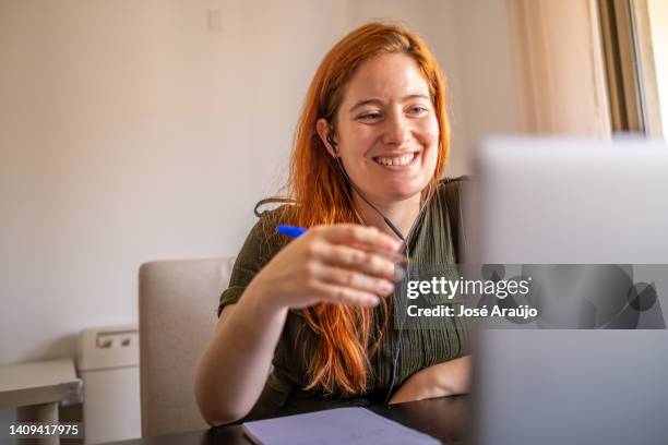 woman taking online courses with laptop and notebook and pen - pessoas notebook stock pictures, royalty-free photos & images