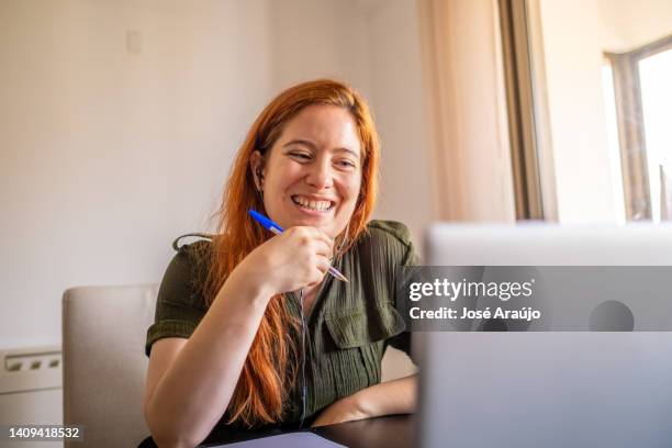 woman taking online courses with laptop and notebook and pen - pessoas notebook stock pictures, royalty-free photos & images