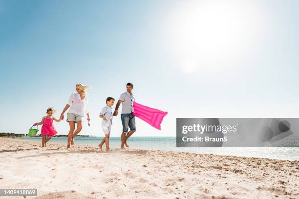 below view of happy family walking on the beach. - egypt beach stock pictures, royalty-free photos & images