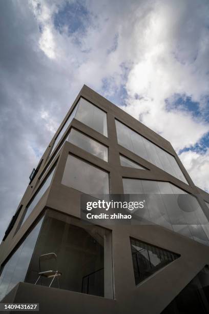 low angle view of office chairs in building in cloudy weather - employability stock pictures, royalty-free photos & images